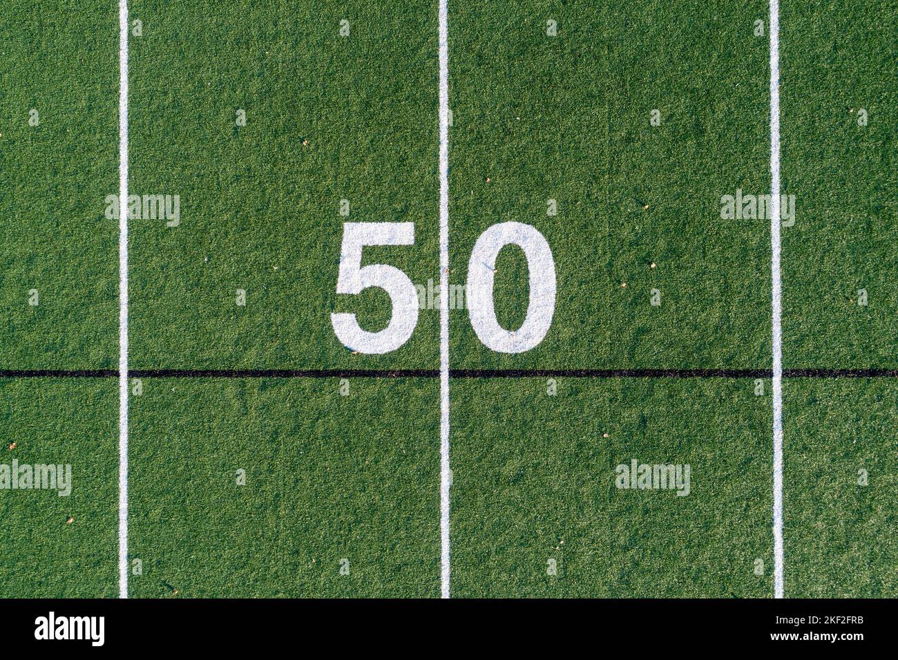 Aerial image of a typical grass football field 50 yard line in white