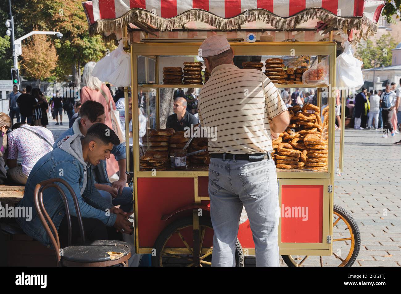Istanbul, Turkey - October 1 2022: A traditional Turkish street vendor in the tourist district of Sultanahmet sells pretzels out of a food stand in Is Stock Photo