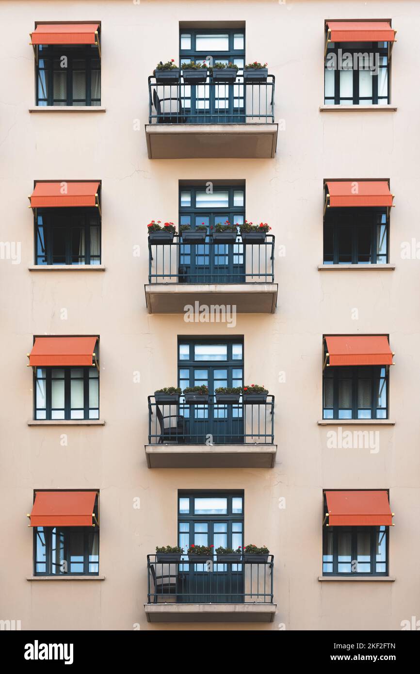 Facade of traditional art deco architecture with French balconies on ...