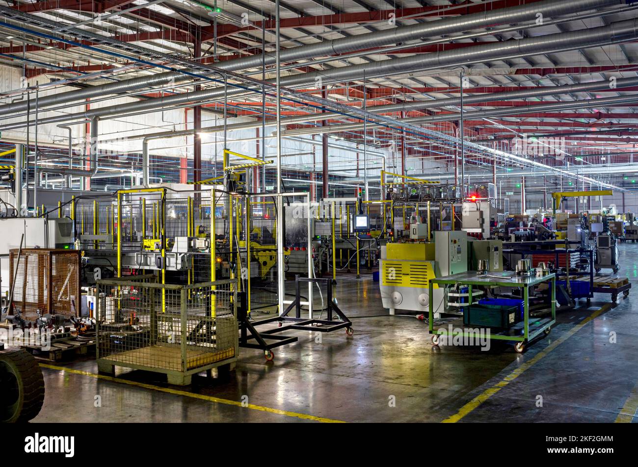 Factory interior. Illuminated by machine lights only (LEDs etc.). One hour long exposure. Car parts factory in Wales. Stock Photo