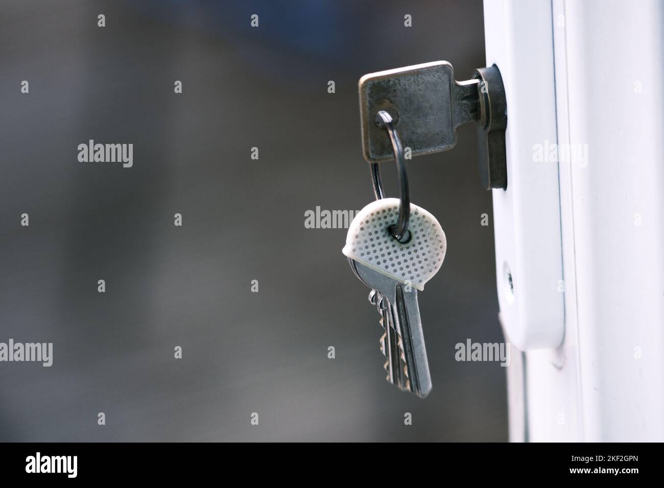 Photograph of keys and keyring in lock of open door Stock Photo Alamy