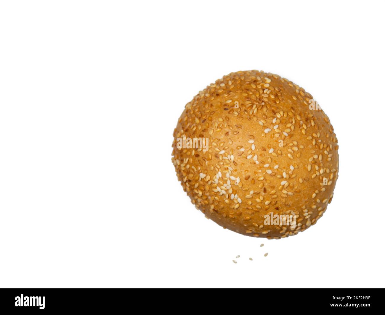 Round bun sprinkled with sesame seeds. Calorie food. Bakery product