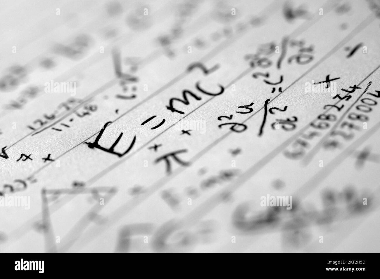 Jumbled, chaotic macro image of hand written equations and calculations on lined paper. Maths anxiety. Mathematical. Math anxiety. Numerical anxiety. Stock Photo