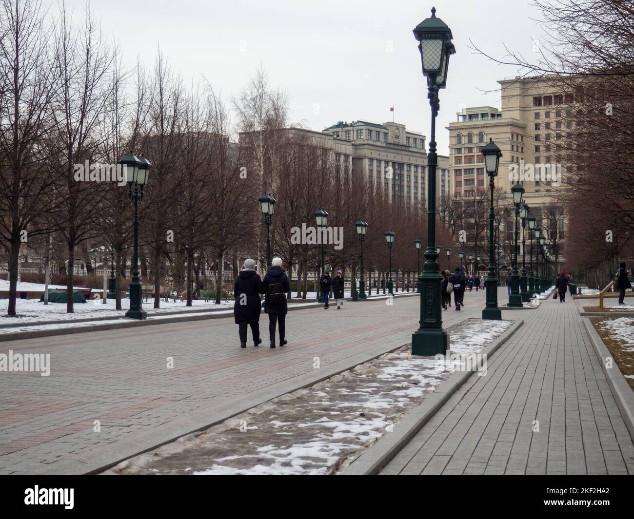 Alley in the park with lanterns. Cold season in the city. Snow in the park. Moscow streets Stock Photo