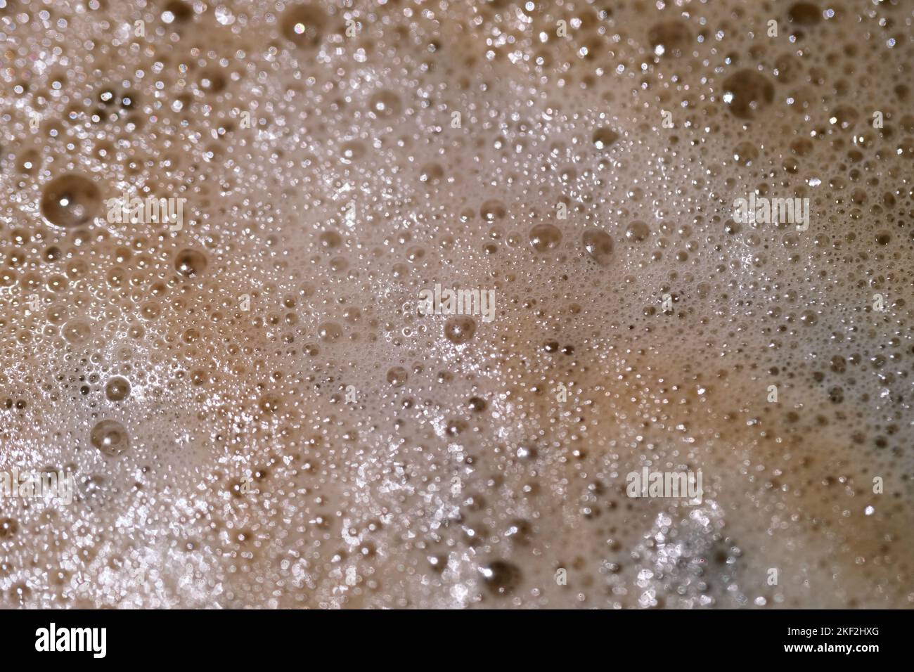 Macro image of froth and bubbles on coffee. Brown and white colour. Close up liquid texture. Stock Photo