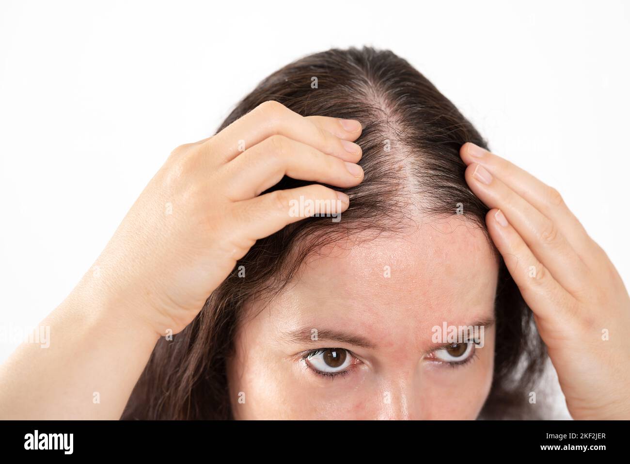 close up of woman controls hair loss Stock Photo