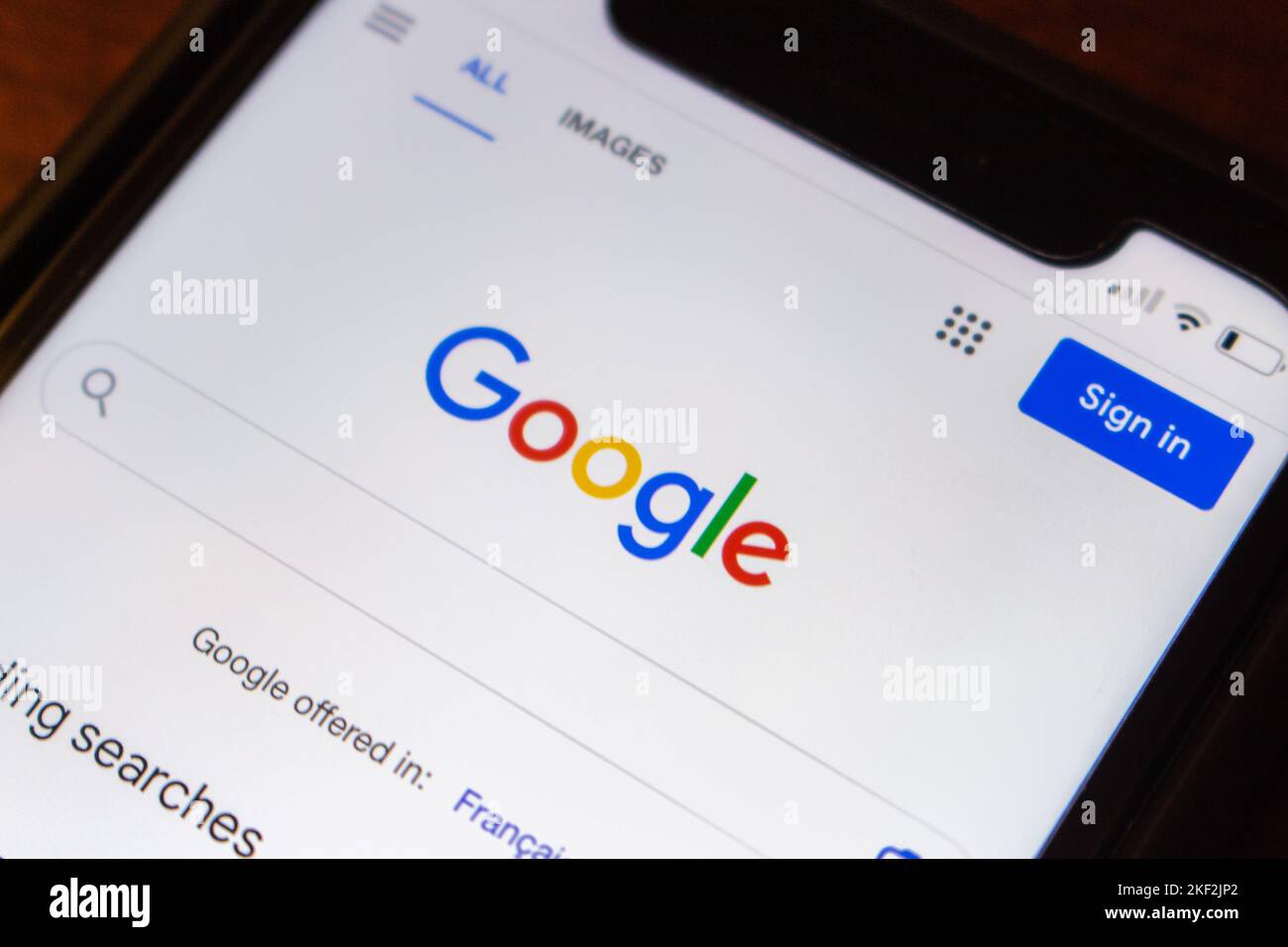 Logo of Google.com website on an iPhone on wooden table. Google LLC is an US multinational technology IT company. Internet SEO search engine concept Stock Photo