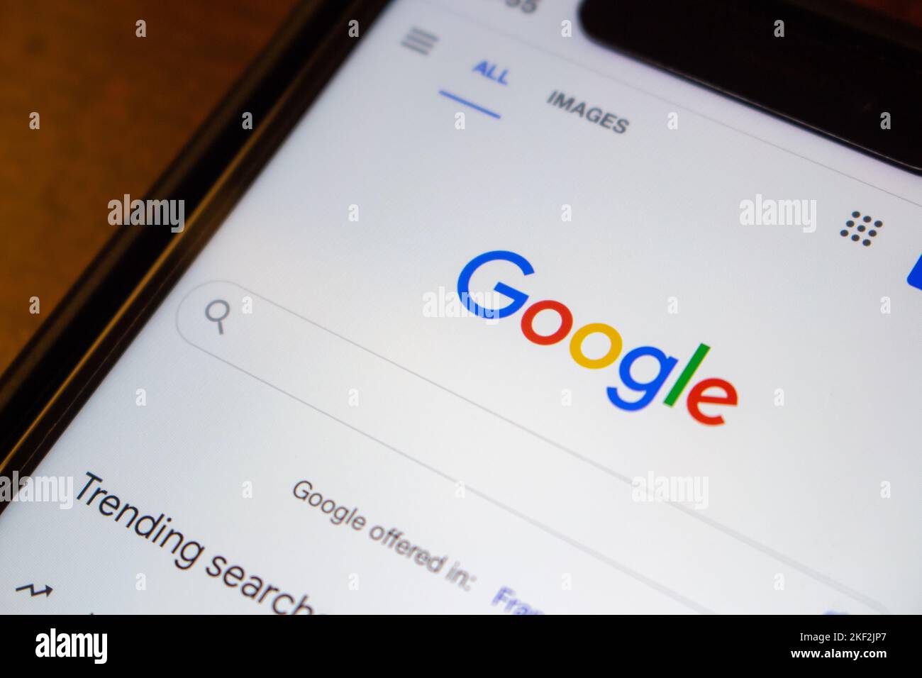 Logo of Google.com website on an iPhone on wooden table. Google LLC is an US multinational technology IT company. Internet SEO search engine concept Stock Photo