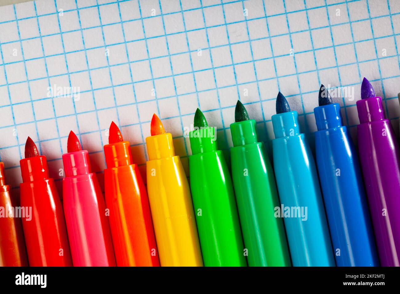 Image of opened multicolored markers on notepad Stock Photo