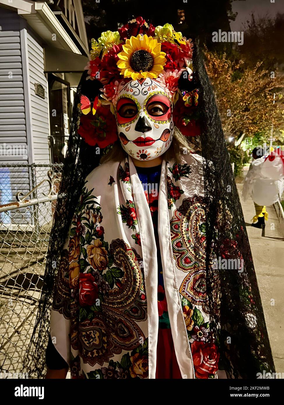 Woman with kids on the street Halloween night  dressed for The Day of the Dead in Brooklyn, New York. Stock Photo