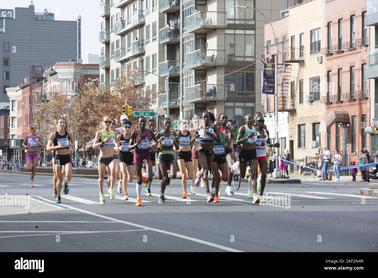 2022 TCS New York City Marathon runners cruise up 4th Avenue through Park Slope Brooklyn during the first leg of the race. Sharon Lokedi from Kenya (right side with red top)eventually won the race. Stock Photo