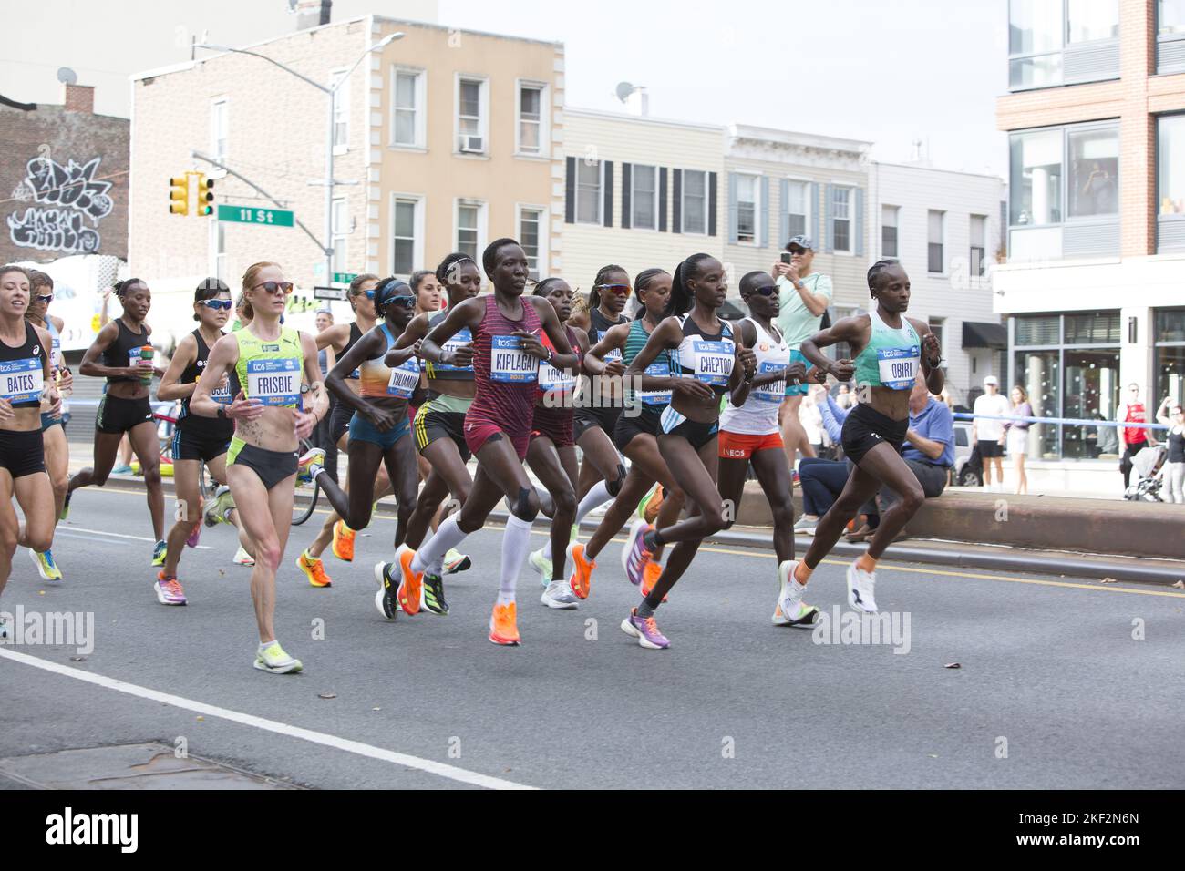 2022 TCS New York City Marathon runners cruise up 4th Avenue through Park Slope Brooklyn during the first leg of the race. Professional front runners including Sharon Lokedi of Kenya who eventually won the race. Stock Photo