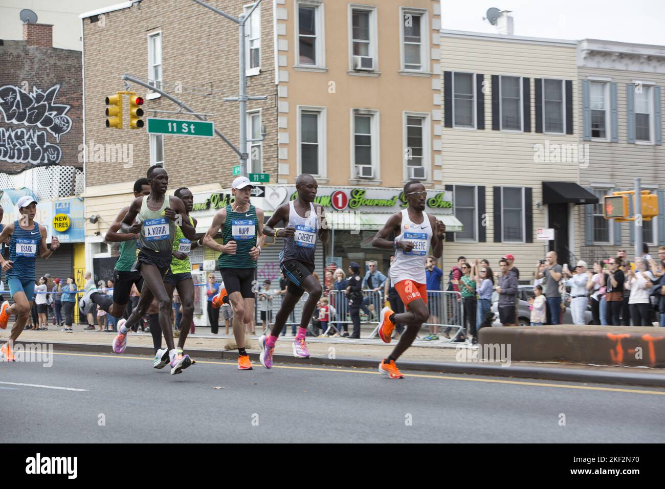 2022 TCS New York City Marathon runners cruise up 4th Avenue through Park Slope Brooklyn during the first leg of the race. Professional male front runners including Evans Chebet from Kenya who eventually won the race. He also previously won the Boston Marathon in 2022. Stock Photo