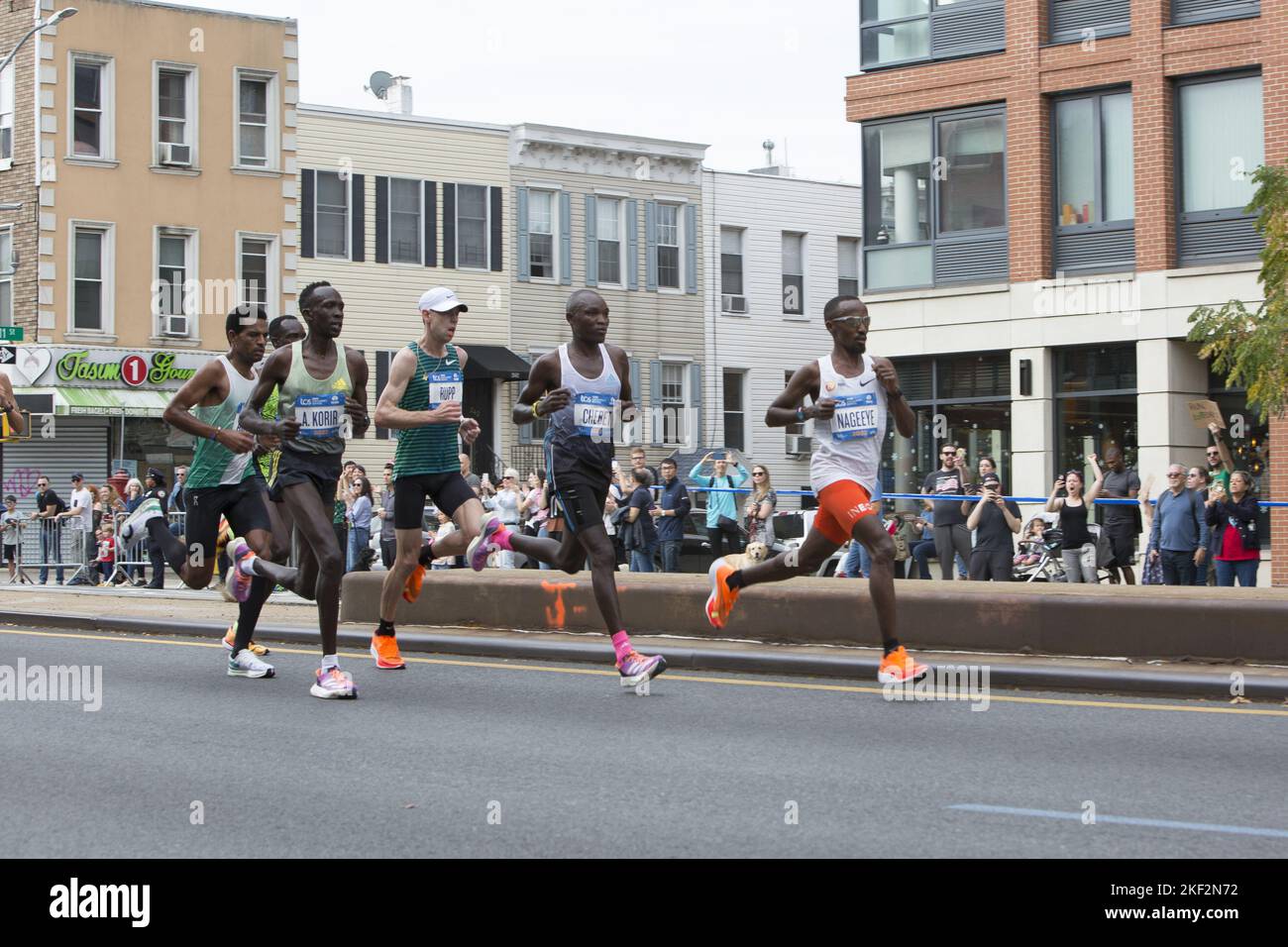 2022 TCS New York City Marathon runners cruise up 4th Avenue through Park Slope Brooklyn during the first leg of the race. Professional male front runners including Evans Chebet from Kenya who eventually won the race. He also previously won the Boston Marathon in 2022. Stock Photo