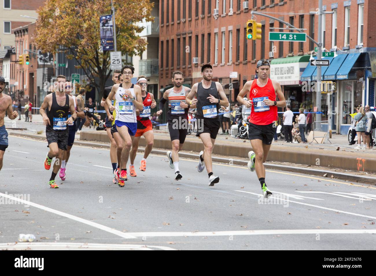2022 TCS New York City Marathon runners cruise up 4th Avenue through Park Slope Brooklyn during the first leg of the race. Stock Photo