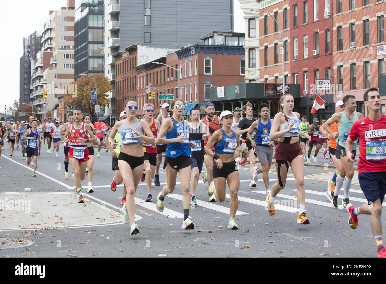 2022 TCS New York City Marathon runners cruise up 4th Avenue through Park Slope Brooklyn during the first leg of the race. Stock Photo