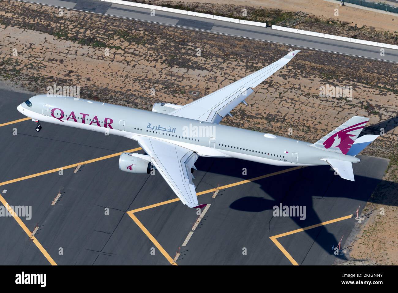 Qatar Airways Airbus A350 aircraft landing. Airplane A350-1000 model of QatarAirways airline A7-ANK. Plane A350-1041 of Qatar Airways from above. Stock Photo