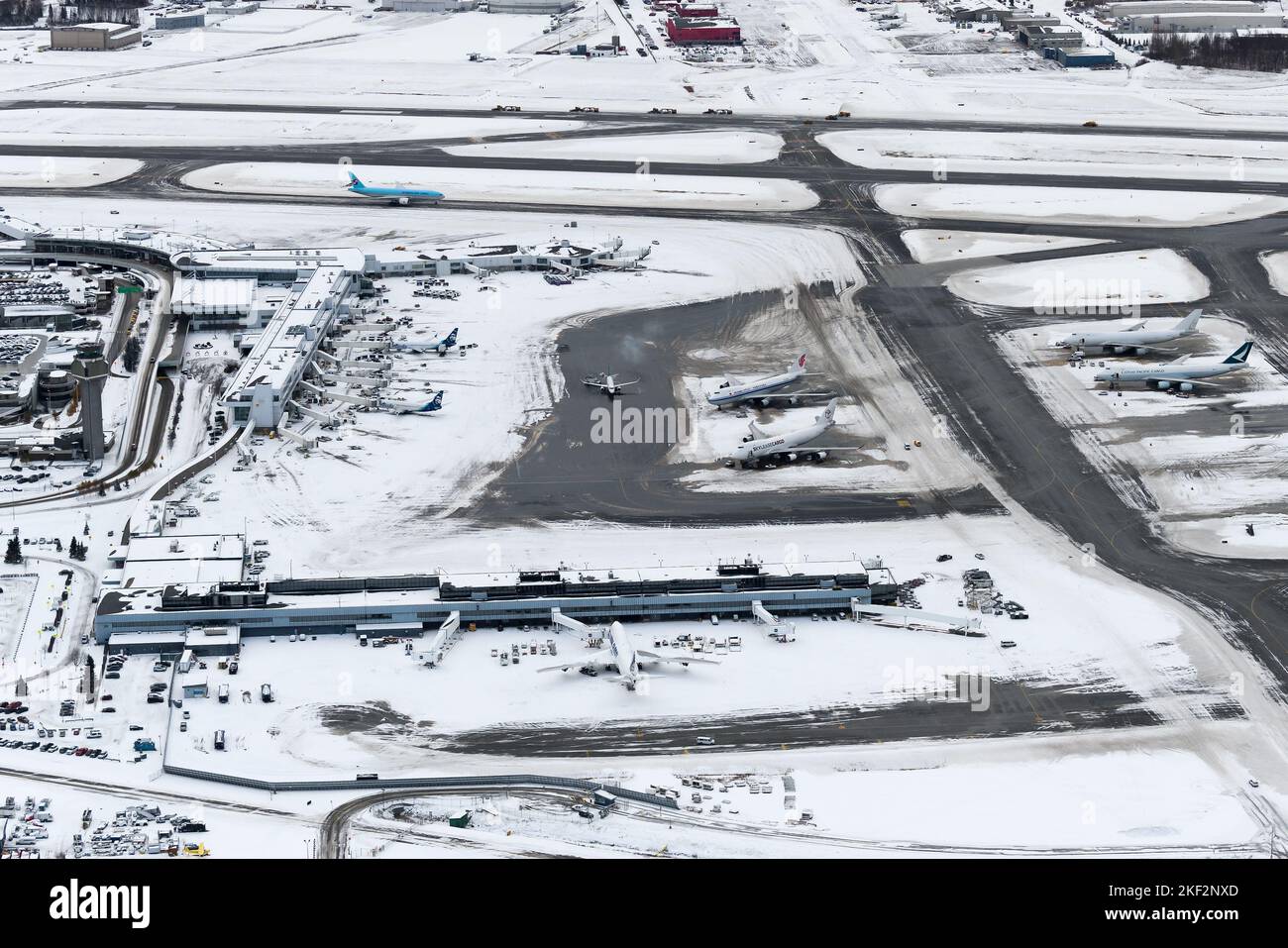 Overview of Anchorage Ted Stevens Airport passengers terminal after a snow fall. Airport winter operations at the cargo hub in Anchorage. Stock Photo