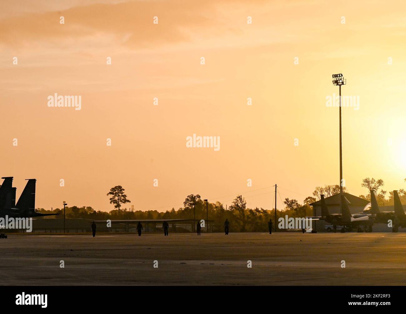 Multiple Airmen conduct a foreign object debris (FOD) walk prior to the ...