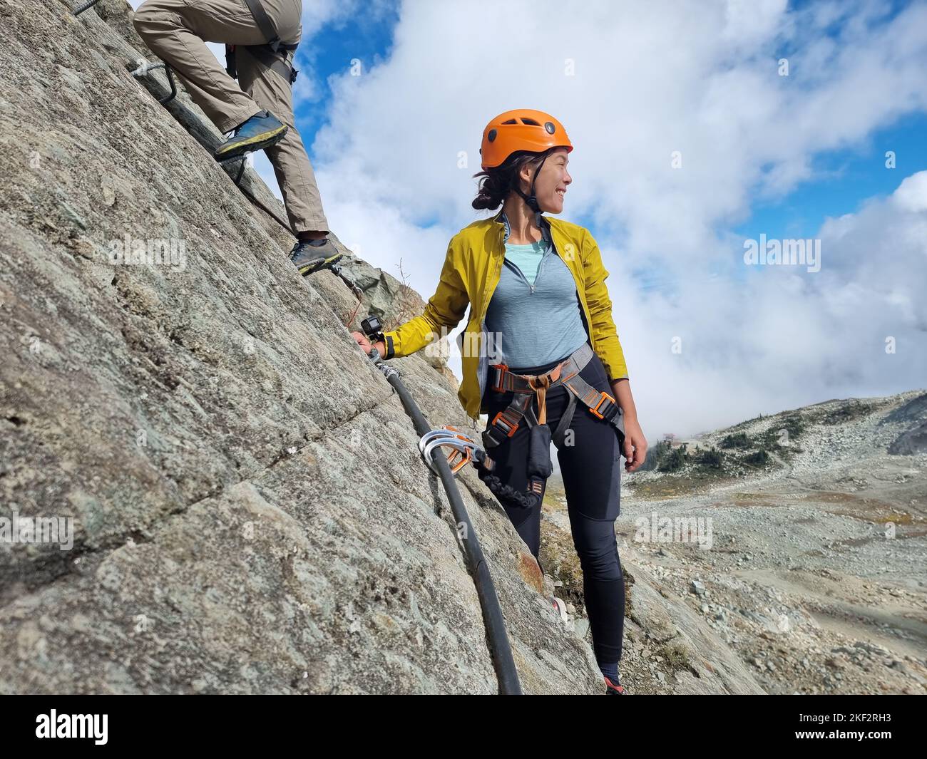 Via Ferrata hiking climbing on the top of Whistler Peak. Guided tour group activity for tourists travel in British Columbia, BC, Canada vacation Stock Photo