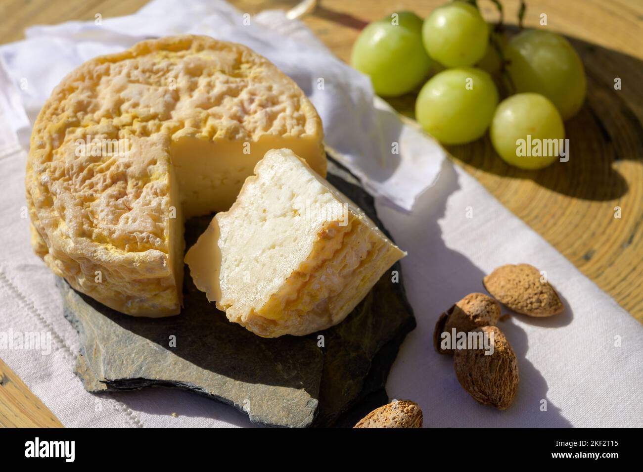 Tasting of local portuguese matured cheese queijo serpa, Setubal area, Portugal, close up Stock