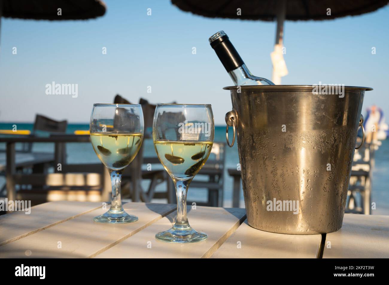 Drinking of cold white wine in beach bar, summer holidays, relax on
