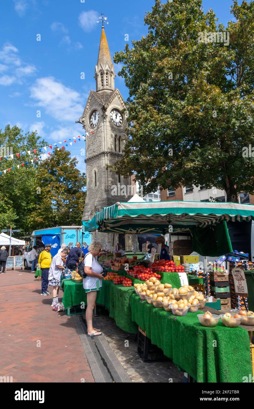 Clock tower and fruit and vegetable stall, The Market Square, Aylesbury, Buckinghamshire, England Stock Photo