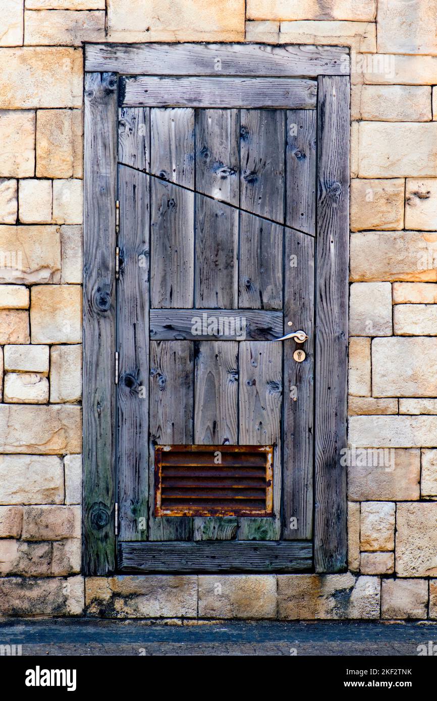 Old wood door in stone wall Stock Photo - Alamy