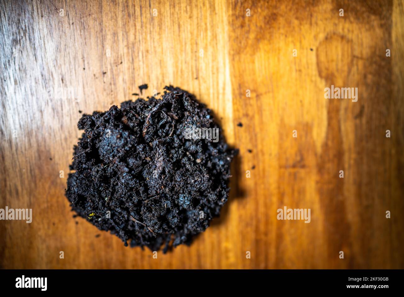 conducting a soil test in a home lab. soil on a table. brown dirt in a ...