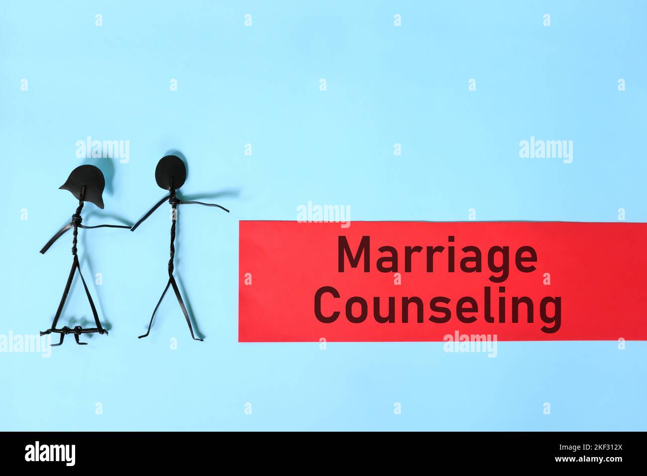 Marriage counseling concept. Couple stick figure on blue background