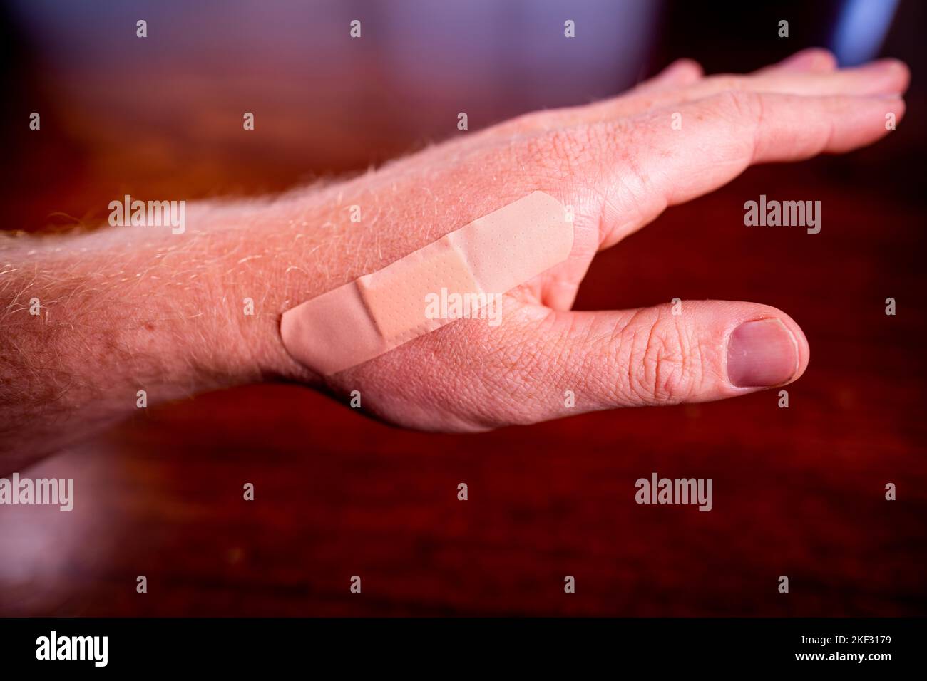 using first aid to apply a band aid to a cut in a hand in a hospital Stock Photo Alamy