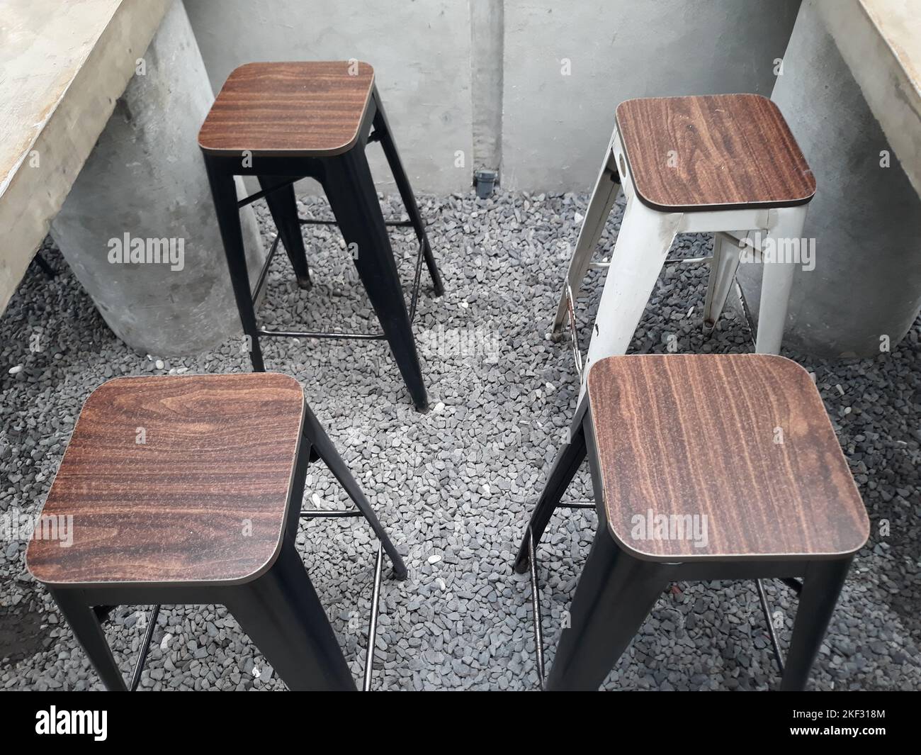 Design Interior a café table and chairs with stone floors and plant
