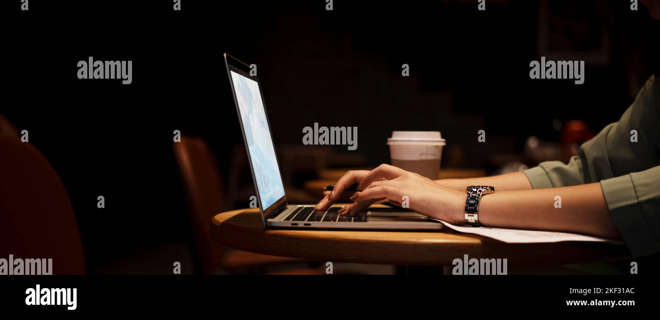 Close up hand asian woman holding pen in casual clothes working in cafe with laptop. Stock Photo