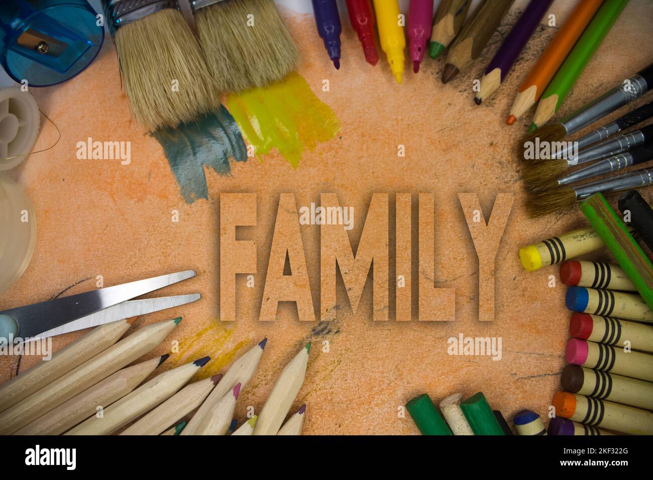 Overhead shot of school supplies with Family text. Brushes, pencils, artistic tools. Art And Craft Work Tools. Stock Photo