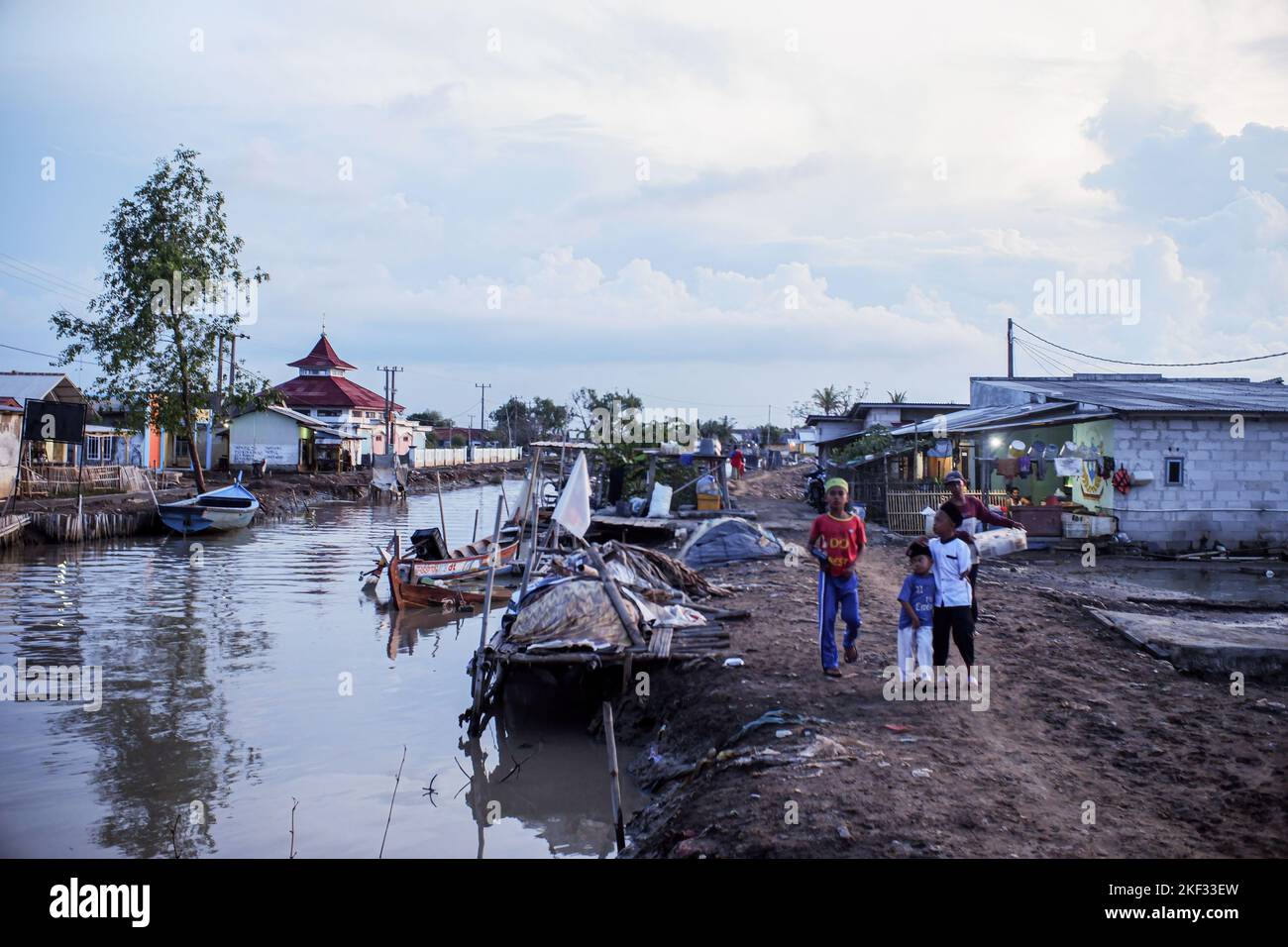 Community activities in the afternoon in Muara Gembong Village. Based on the Climate Central report, a number of areas in the West Java Coastal Coast are predicted to sink in the next 8 years. The threat can also be seen through the Climate Central map regarding the distribution of areas that will sink in 2030. The areas that are predicted to sink based on the Climate Central map are spread from Bekasi, Karawang, Subang, Indramayu to Cirebon. The threat to the Coastal Coast of West Java was mentioned by the Governor of West Java, Ridwan Kamil. Kang Emil, about 200 hectares of land in Bekasi Re Stock Photo