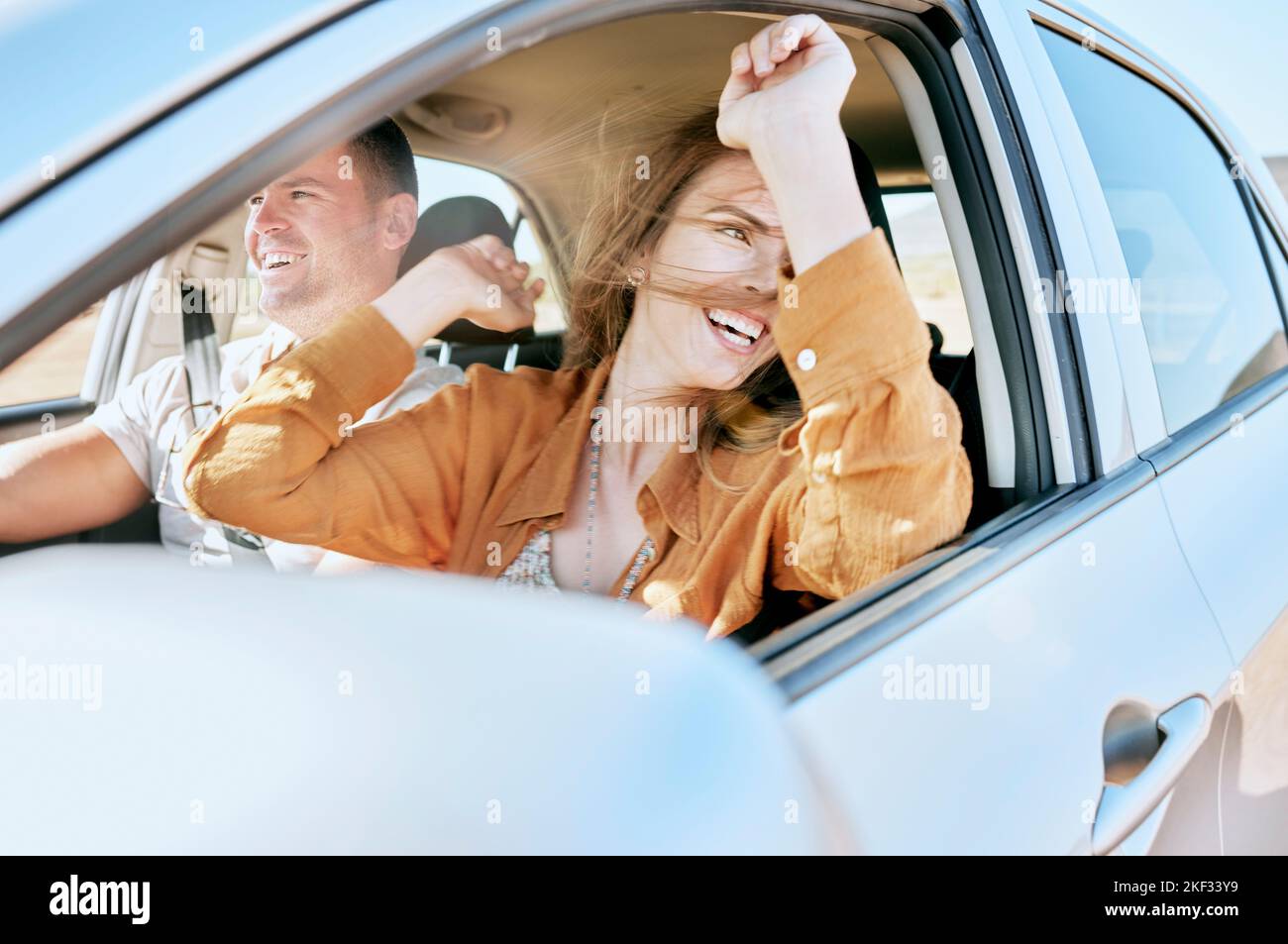 Road trip, travel and couple in a car in nature for freedom, vacation and happiness together. Summer, happy and man with an excited woman with smile Stock Photo