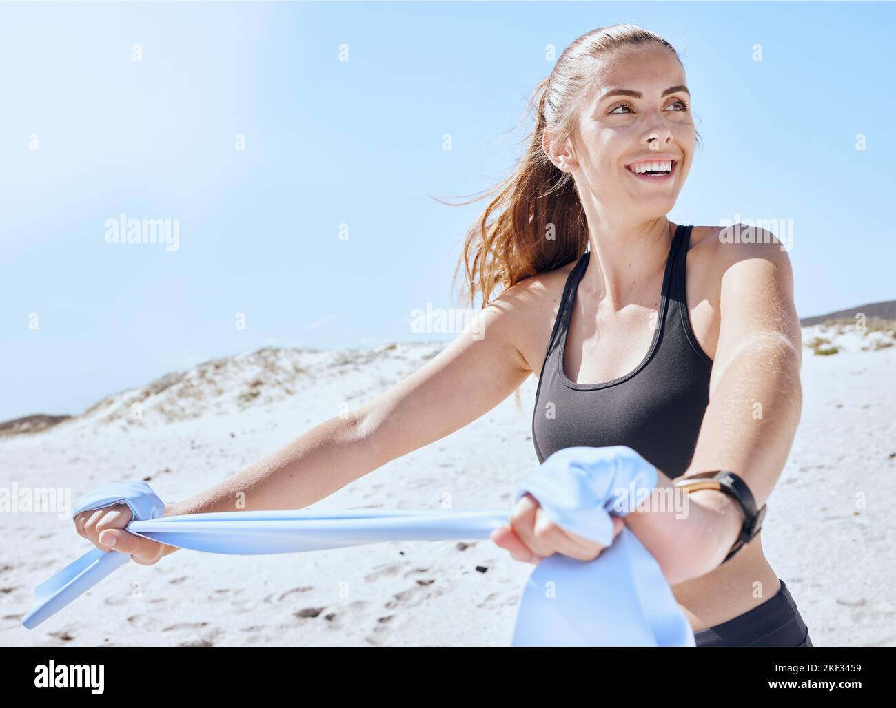 Fitness, beach and band stretch with a woman using a resistance band