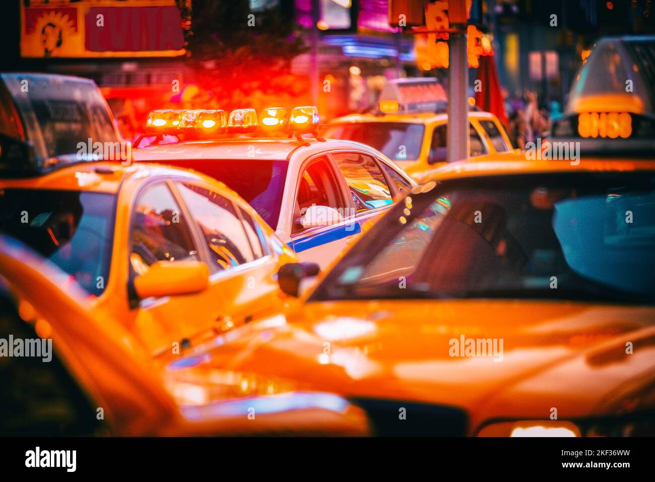 New York City Police patrol car flashing beacon siren lights in busy NYC traffic jam with yellow taxi cabs cars. Urban background Stock Photo