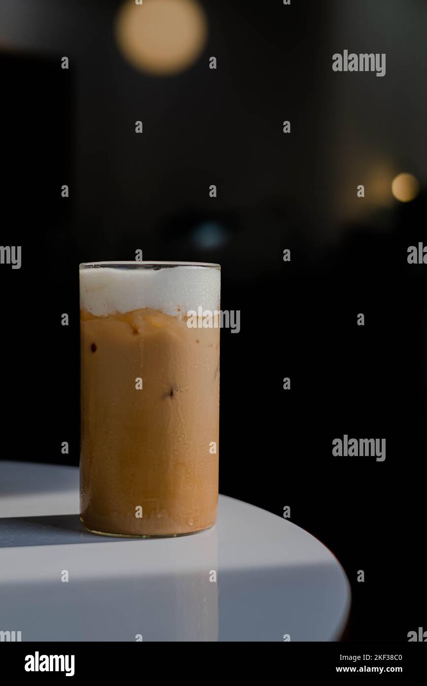 https://c8.alamy.com/comp/2KF38C0/coffee-latte-or-cappuccino-served-in-a-glass-on-a-white-table-with-dark-background-2KF38C0.jpg