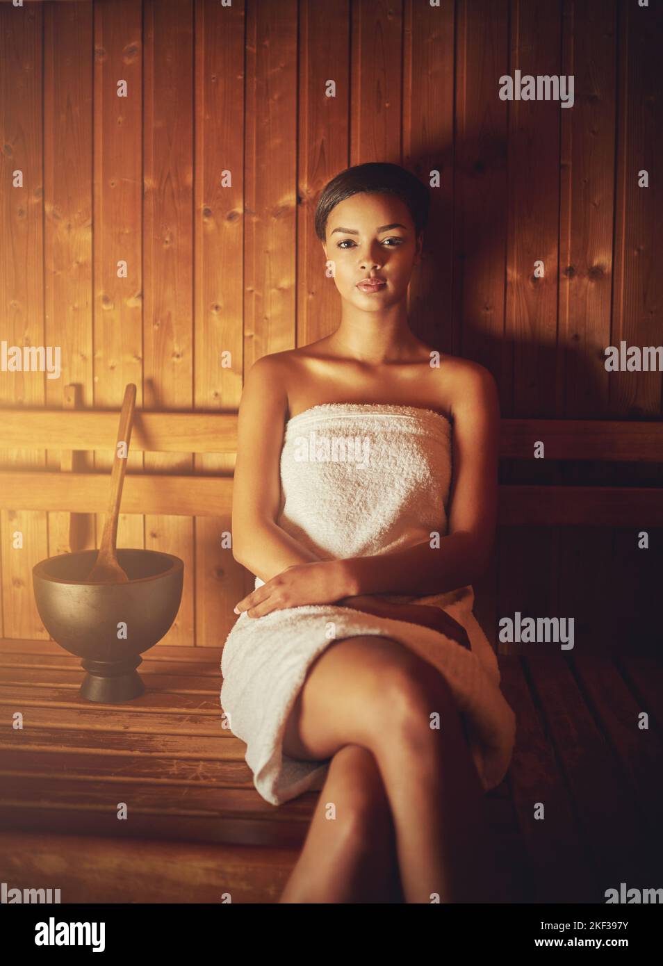 This sauna feels amazing. Cropped portrait of a young woman relaxing in the sauna at a spa. Stock Photo