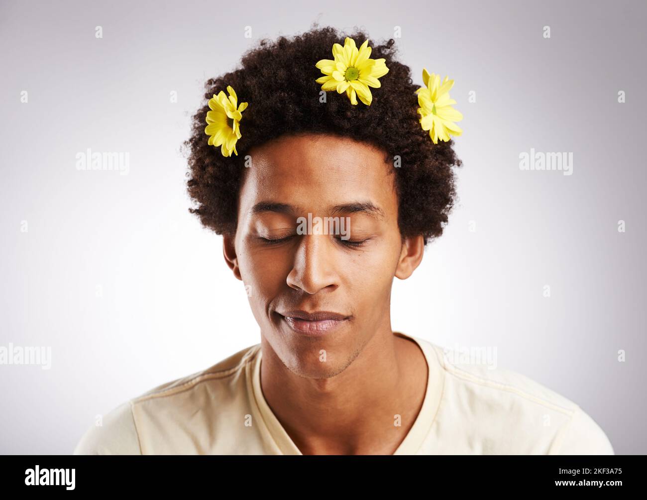 Be the flower, feel the flower. a young man with flowers in his hair