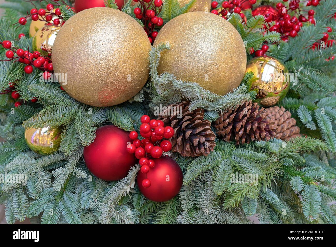 Christmas tree is decorated with Christmas balls, red berries and pine
