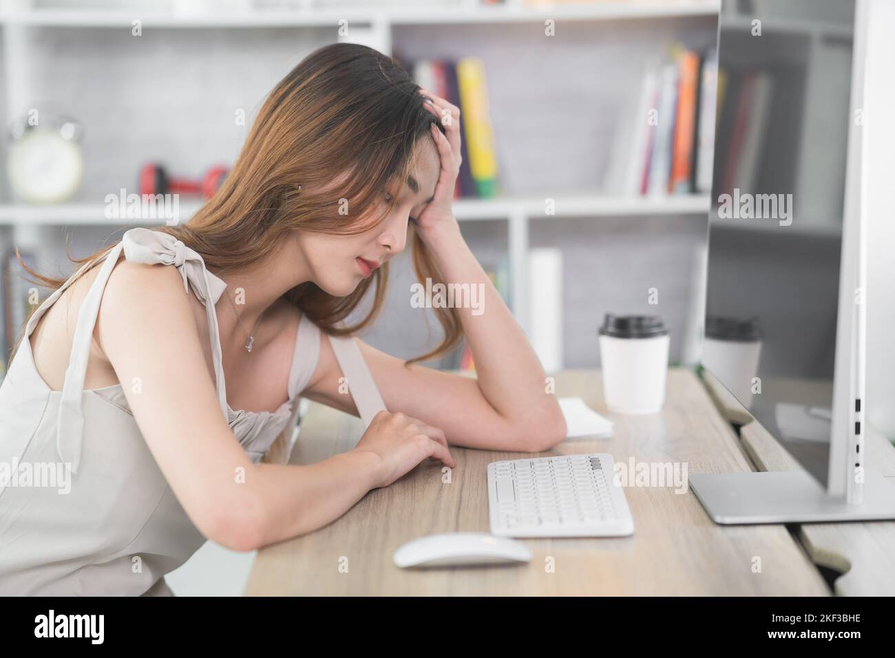 Asian business woman having stressful depression sad time working on laptop or computer on wood table at home office. Depression man sad serios workin Stock Photo