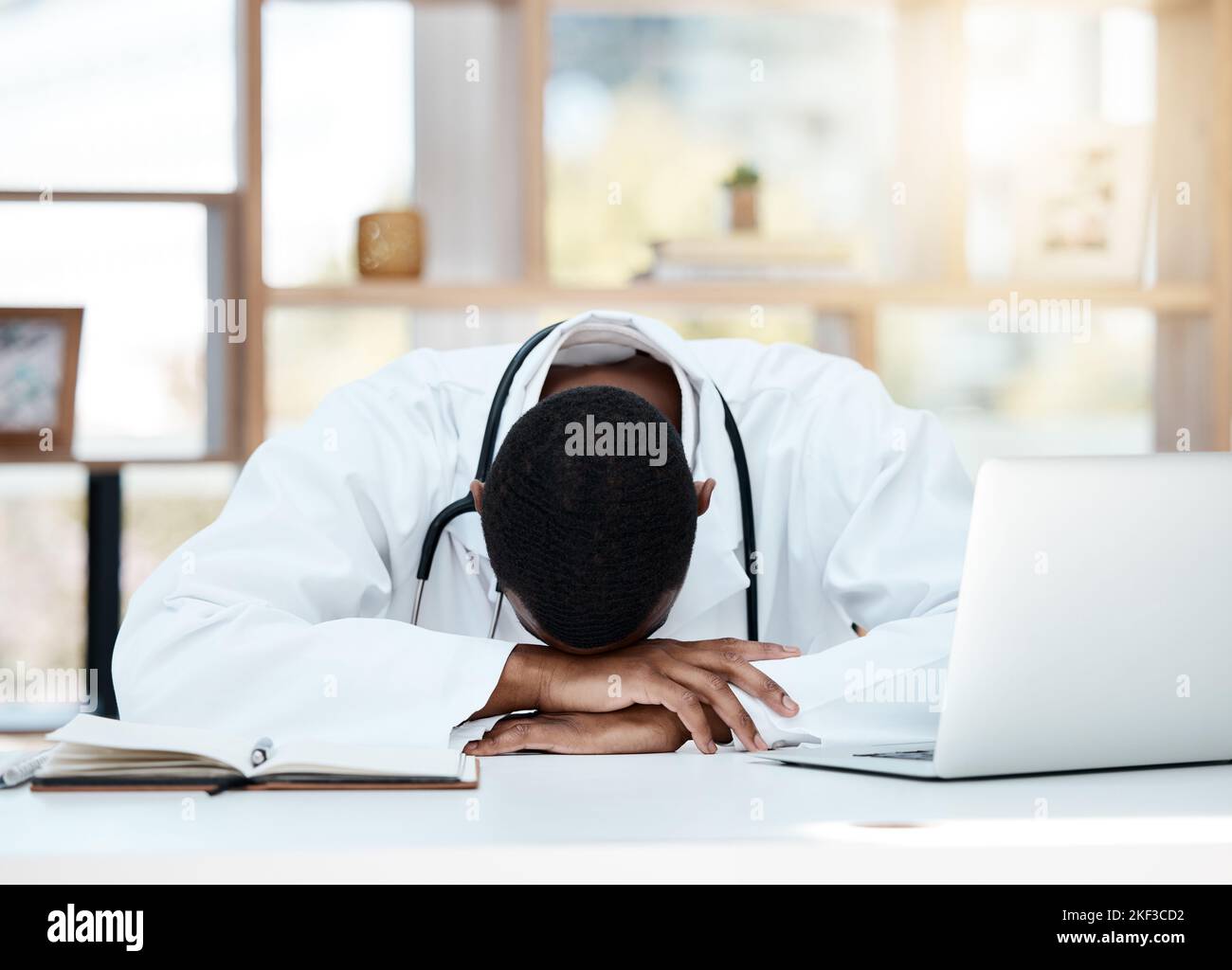 Doctor, tired and stress in office with anxiety, depression or headache in hospital, workplace or work room. Burnout, sad and mental health medic with Stock Photo