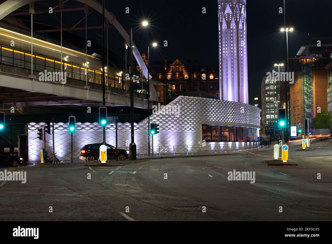 Tower of Light and Wall of Energy low carbon energy centre. Manchester UK. Shell Lace Structure Tonkin Liu. Light trails from Metrolink tram Stock Photo