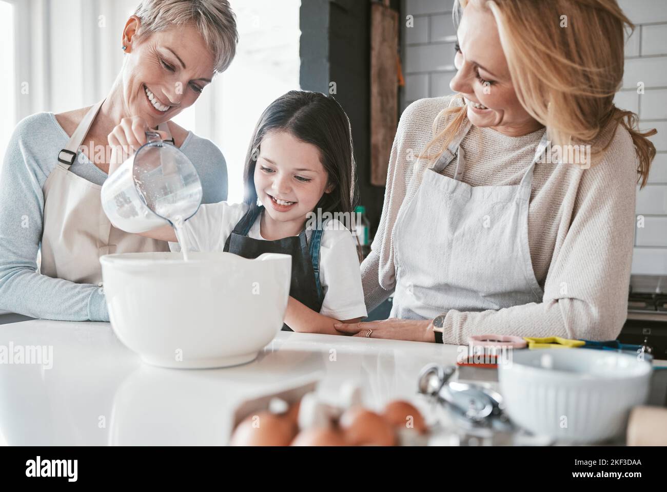 .Cooking, kitchen and grandmother with child teaching, learning and helping together for mothers day cake, cookies or breakfast. Bonding family, mom Stock Photo