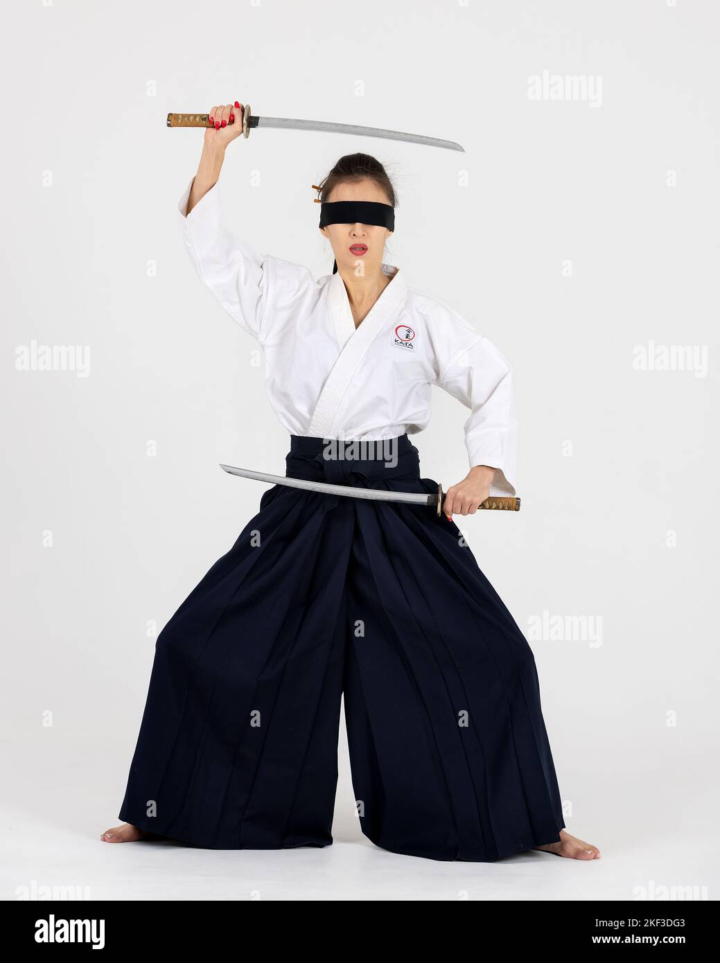 Aikido master woman in traditional samurai hakama kimono with black belt  with sword, katana on white background. Healthy lifestyle and sports  concept Stock Photo - Alamy
