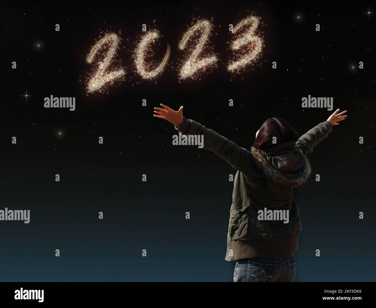 happy Asian girl open arm with joyful on countdown night with firework light for 2023 year. image of happy new year celebration party for seasonal and Stock Photo