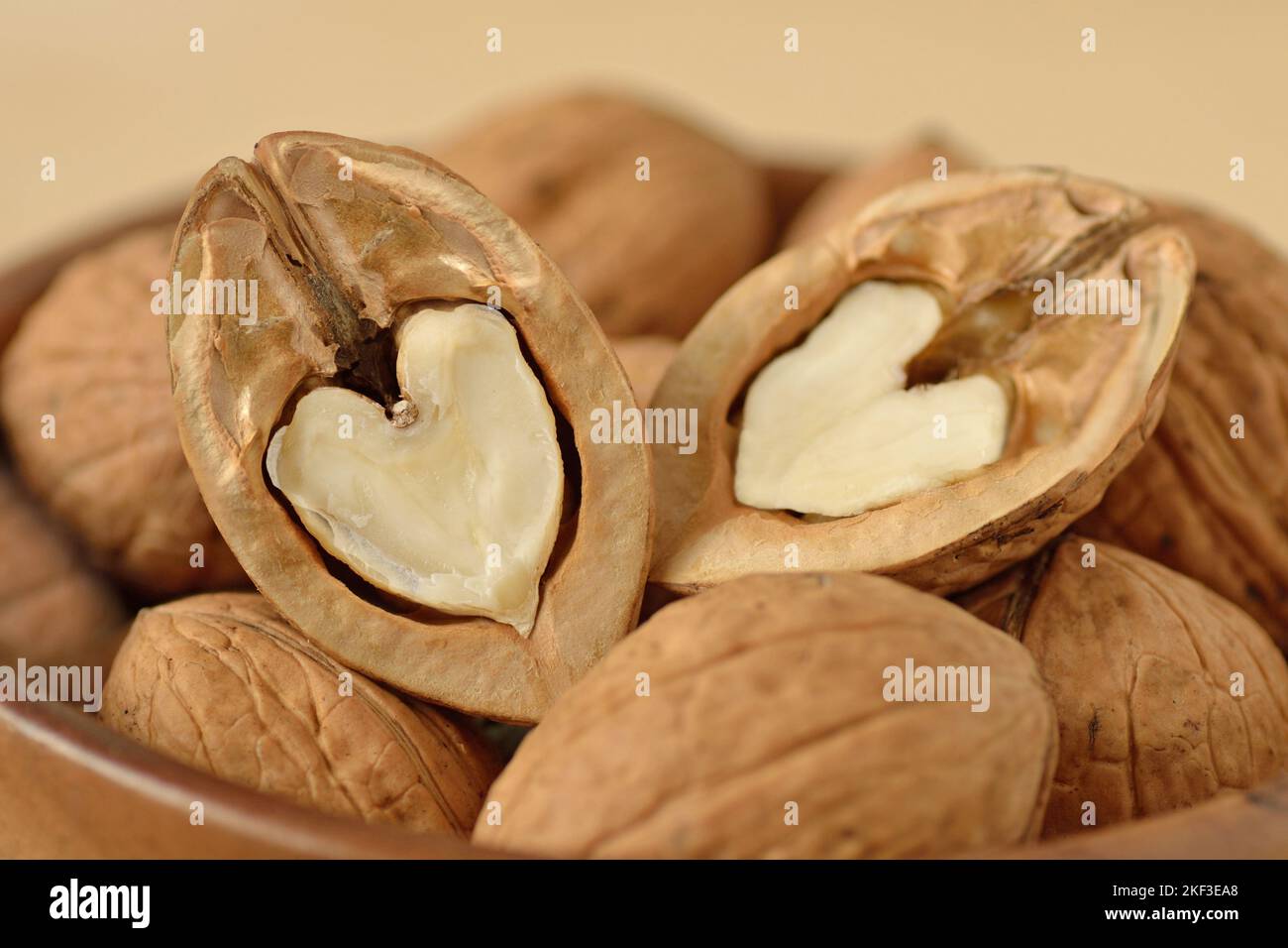 Close-up of two halves of heart shaped walnuts  - Concept of love Stock Photo