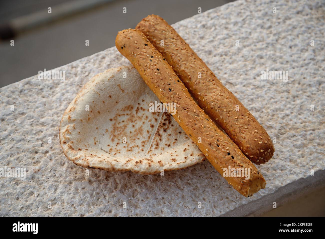 Jordanian flat bread and seeded bread sticks. Middle Eastern staple diet of wheat based food. Stock Photo